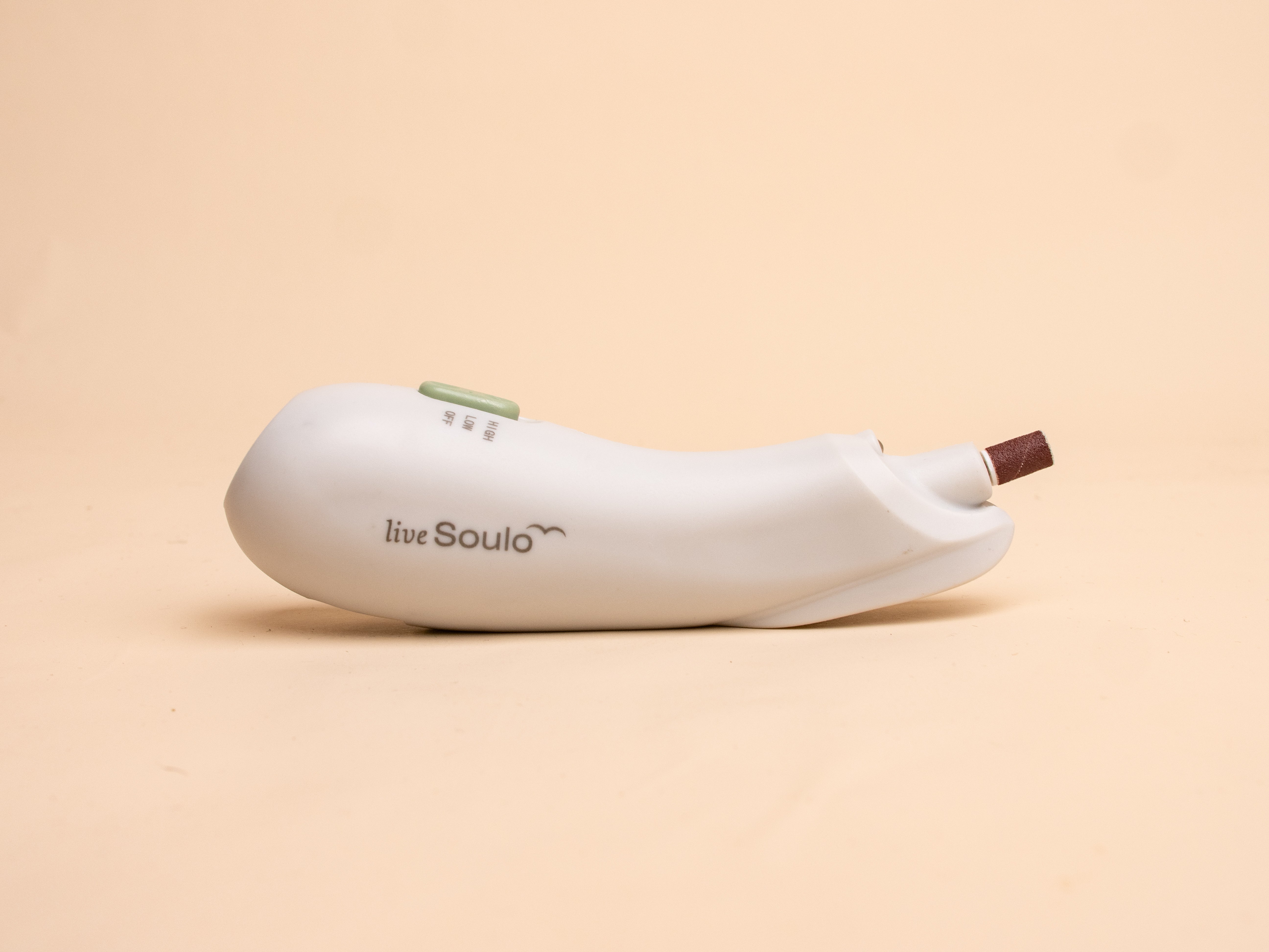 White electronic device with 'liveSoulo' branding on a beige background